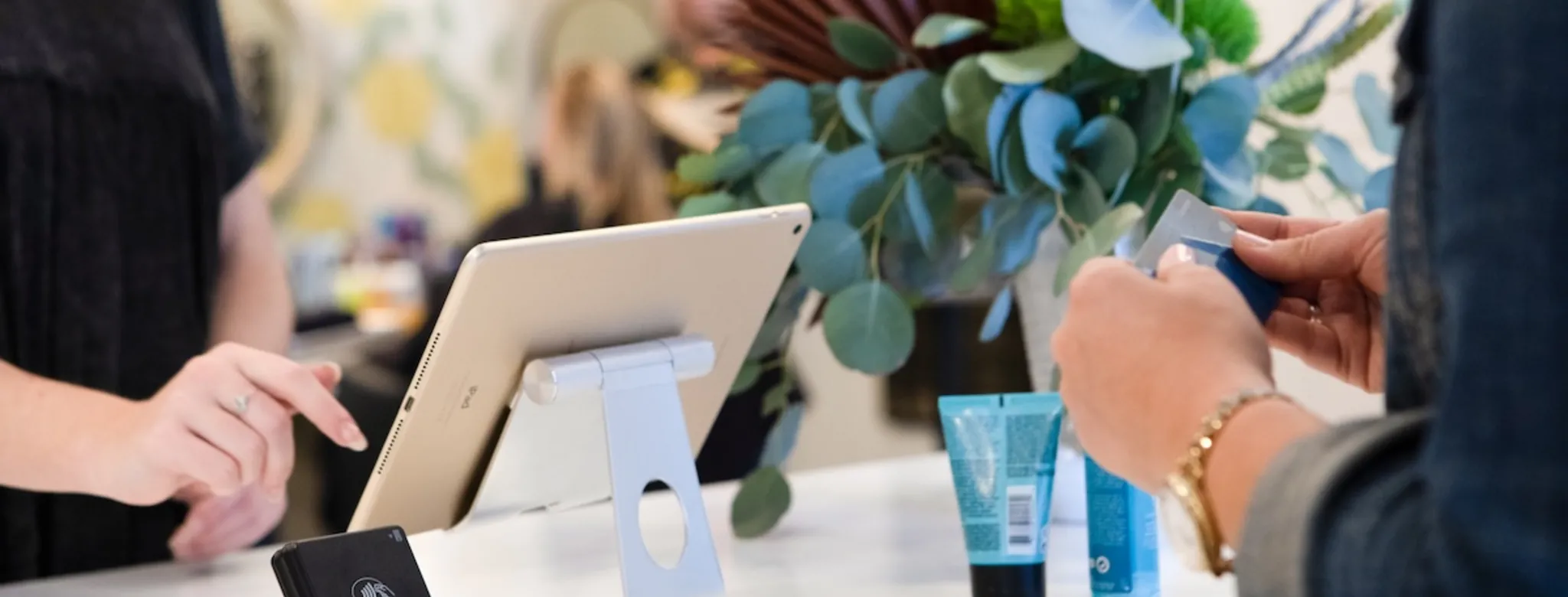 A customer making a payment at the salon