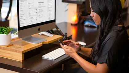 An employee works at a wellness business front desk