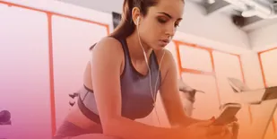 Person wearing headphones and using cell phone