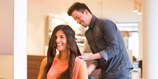 Client in chair talking with stylist